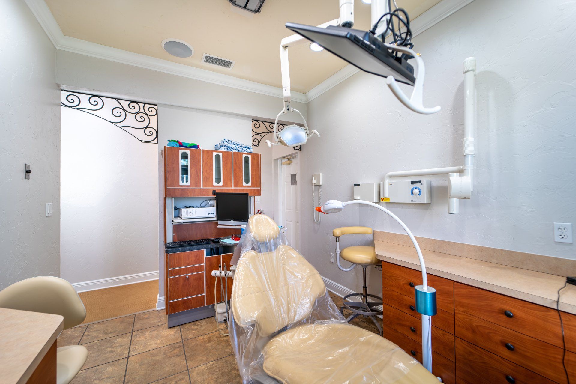 A dental office with a dental chair and a desk