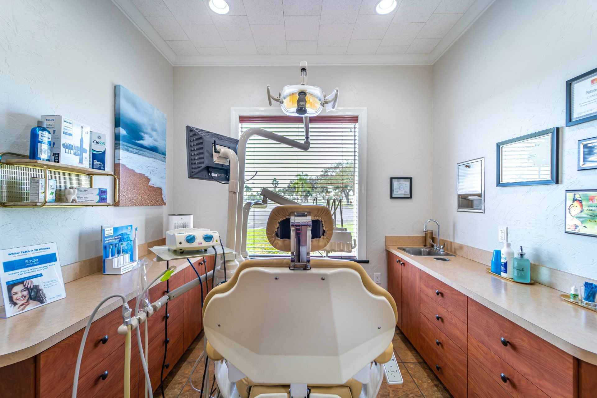 A dental office with a dental chair and a window.