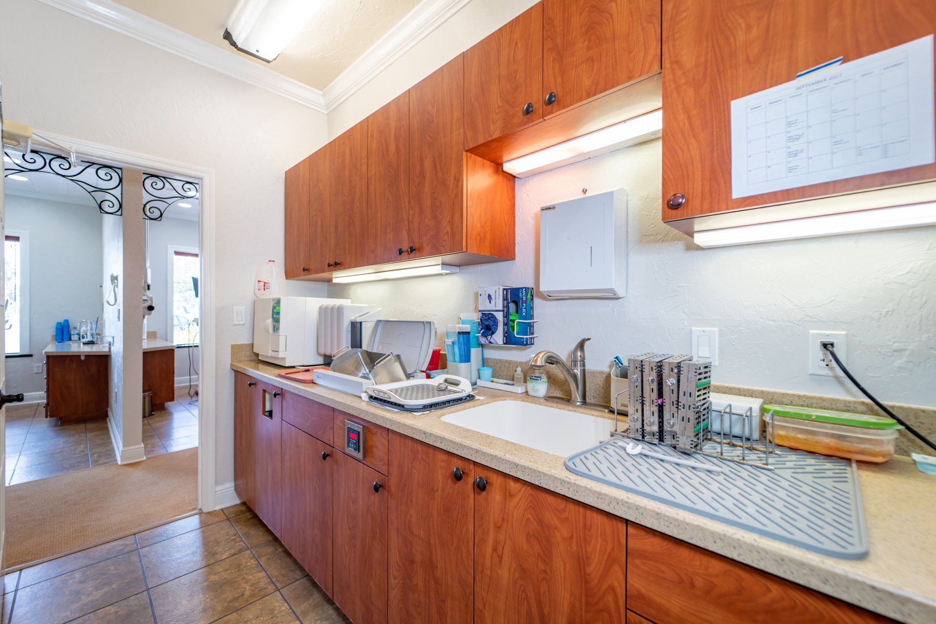 A kitchen with wooden cabinets and a sink.