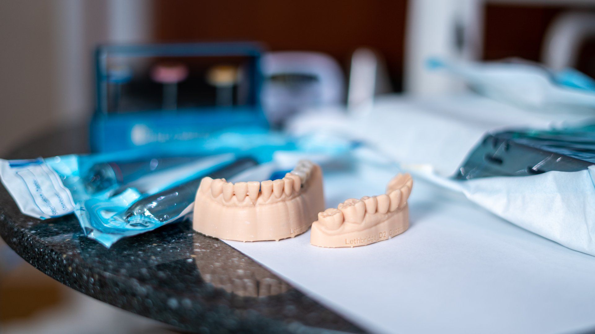 A pair of dentures sitting on top of a table next to a toothbrush and toothpaste.