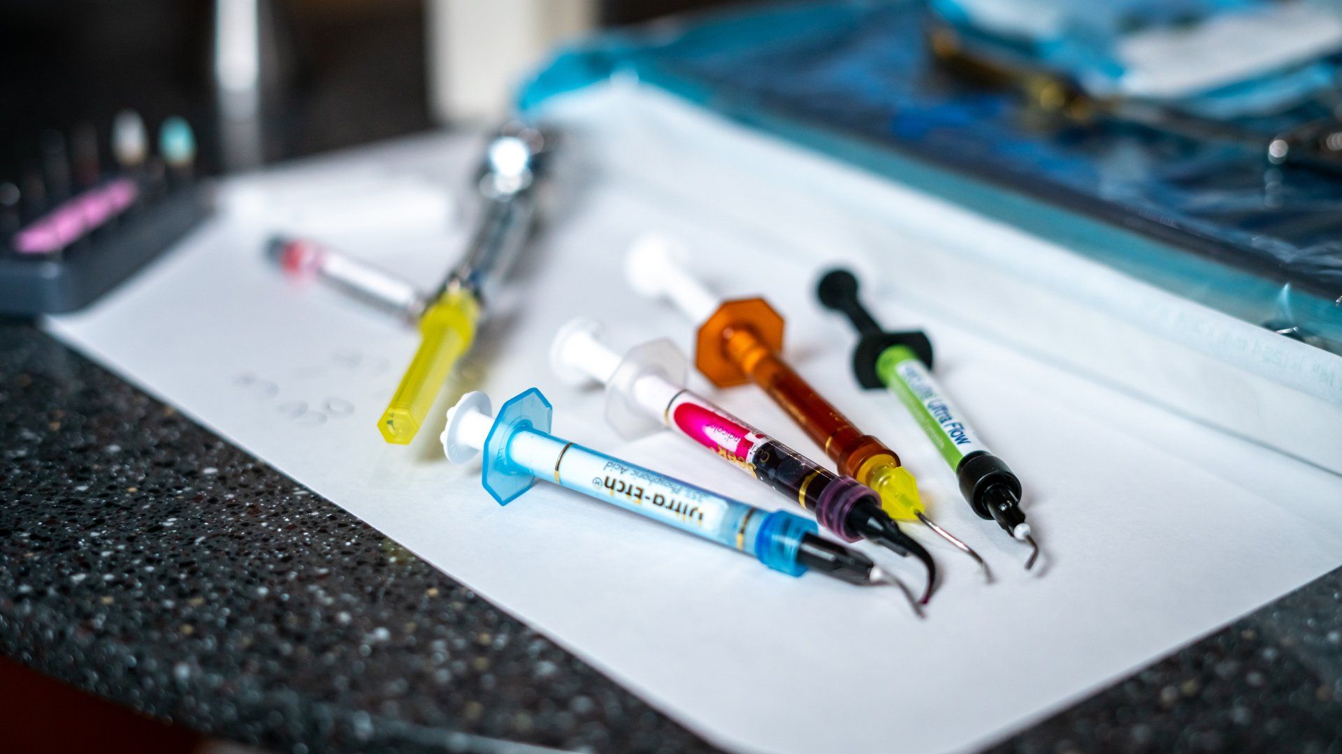 A bunch of syringes are sitting on top of a piece of paper.
