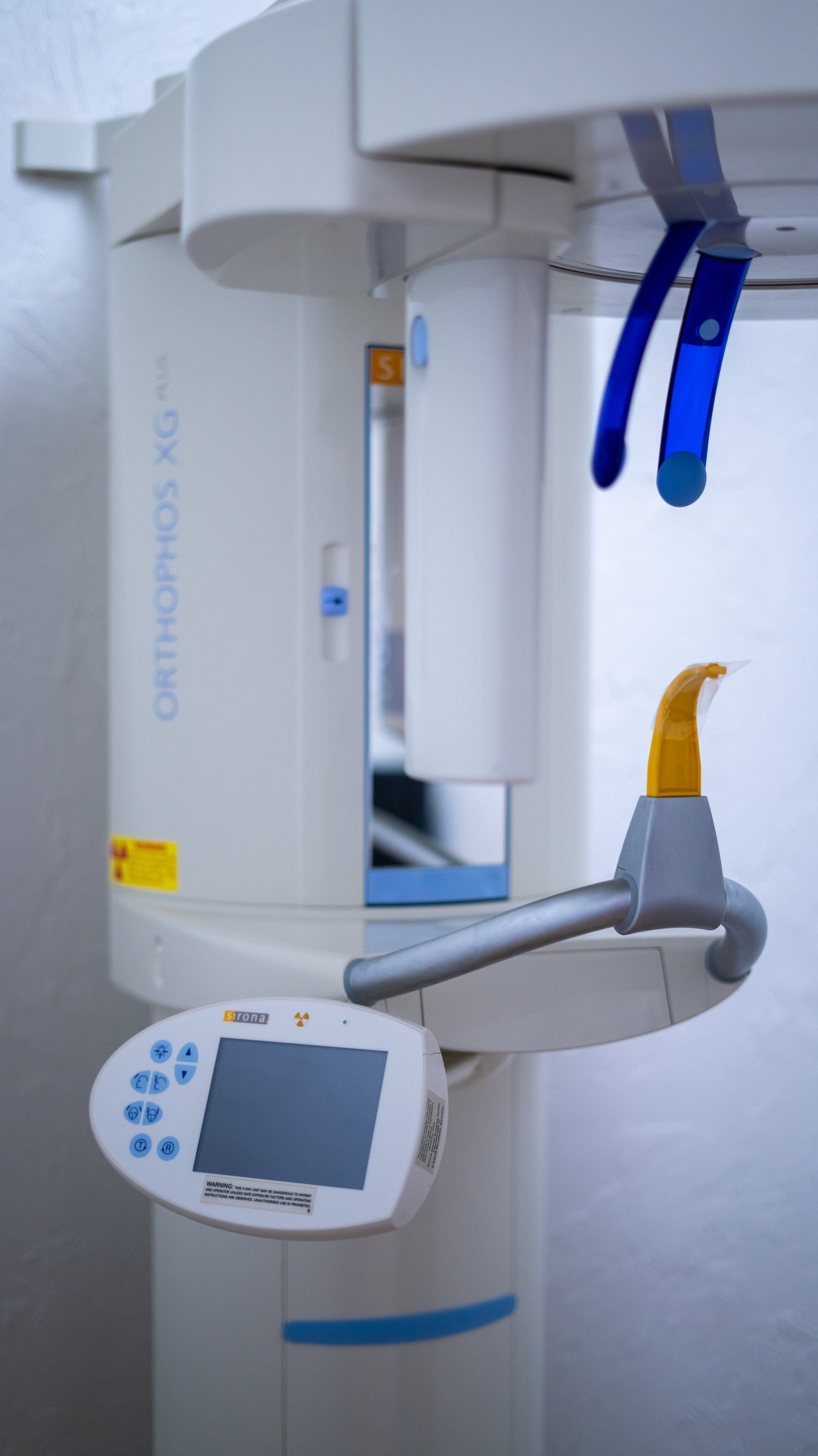 A close up of a dental x-ray machine in a dental office.