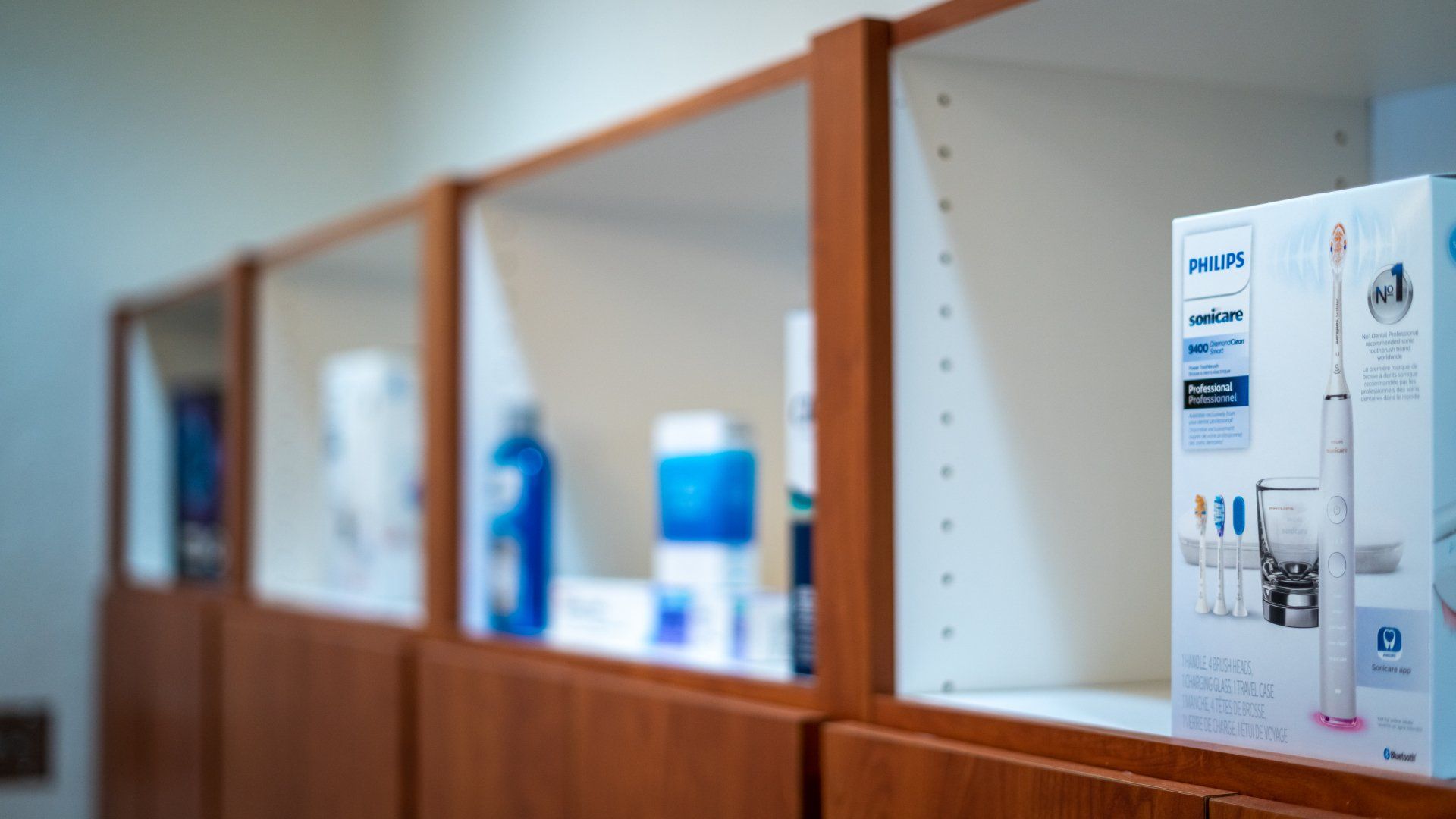 A row of shelves with bottles and boxes on them.
