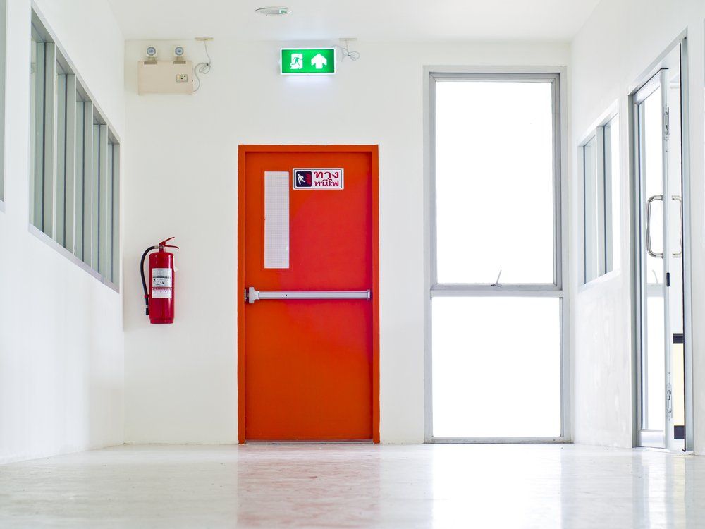 Emergency Exit with Fire Extinguisher — Electrical & Fire Services in Darwin, NT