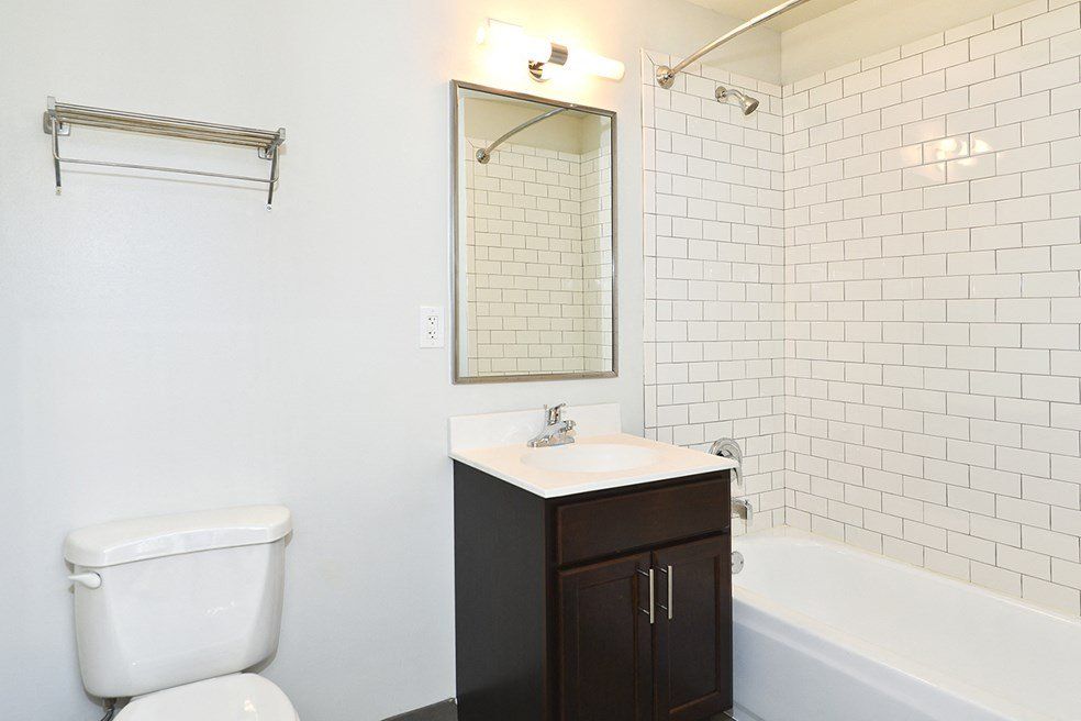 A bathroom with a toilet , sink , and bathtub at 1471 N Milwaukee Apartments.
