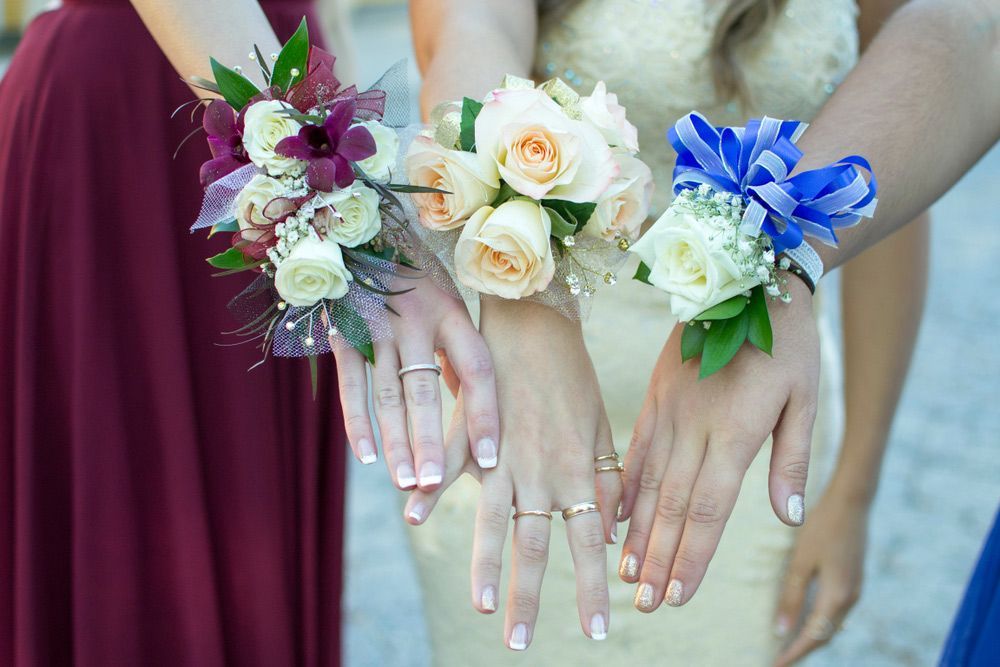 A Group of Women Wearing Flowers on Their Wrists — Pick-A-Bunch Florists & Gifts In Sarina, QLD