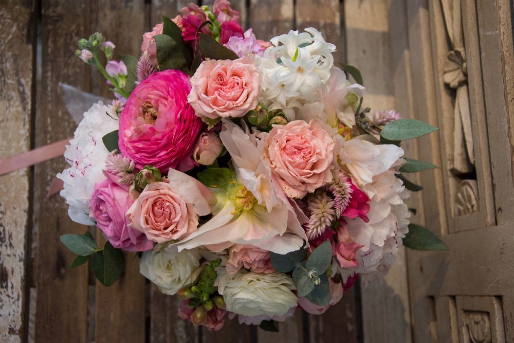 A Bouquet of Pink and White Flowers Is Sitting on A Wooden Table — Pick-A-Bunch Florists & Gifts In Koumala, QLD