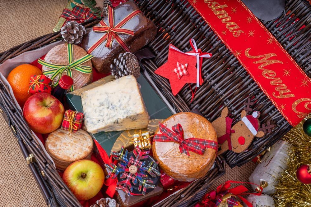 A Wicker Basket Filled with Christmas Food and Decorations — Pick-A-Bunch Florists & Gifts In Alligator Creek, QLD