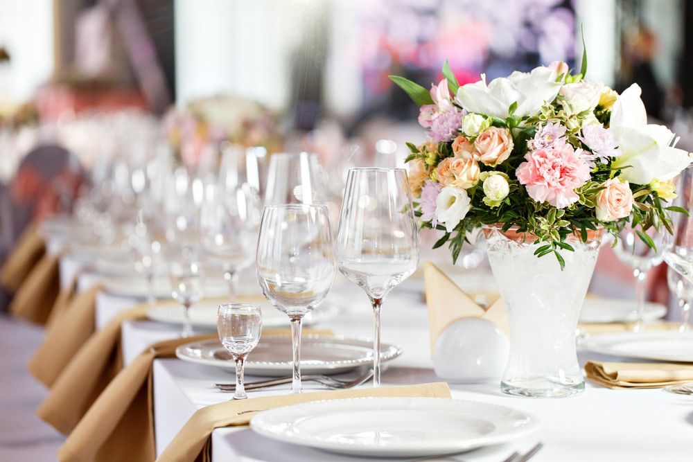 A Table Set with Plates, Glasses, and A Vase of Flowers — Pick-A-Bunch Florists & Gifts In Alligator Creek, QLD