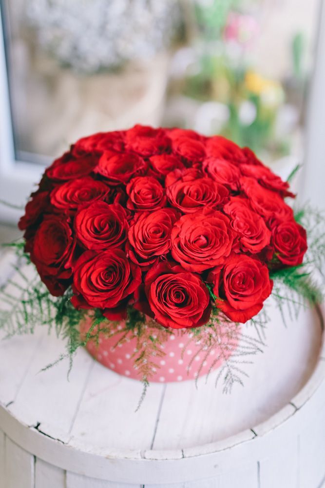 A Bunch of Red Roses in A Pink Box on A Table — Pick-A-Bunch Florists & Gifts In Koumala, QLD