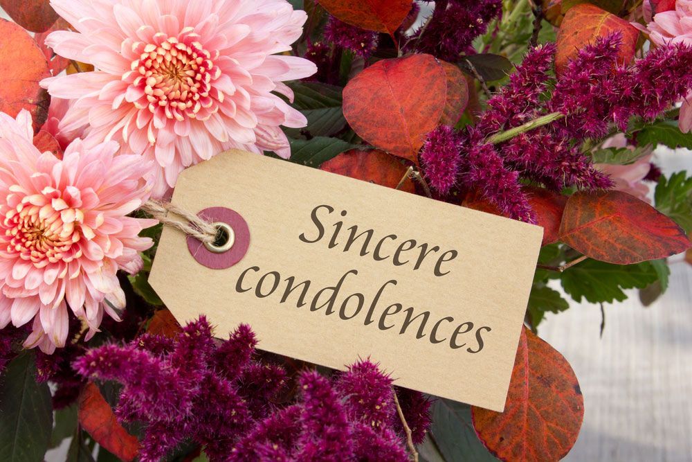 A Bouquet of White Flowers and A Lit Candle on A Table — Pick-A-Bunch Florists & Gifts In Armstrong Beach, QLD