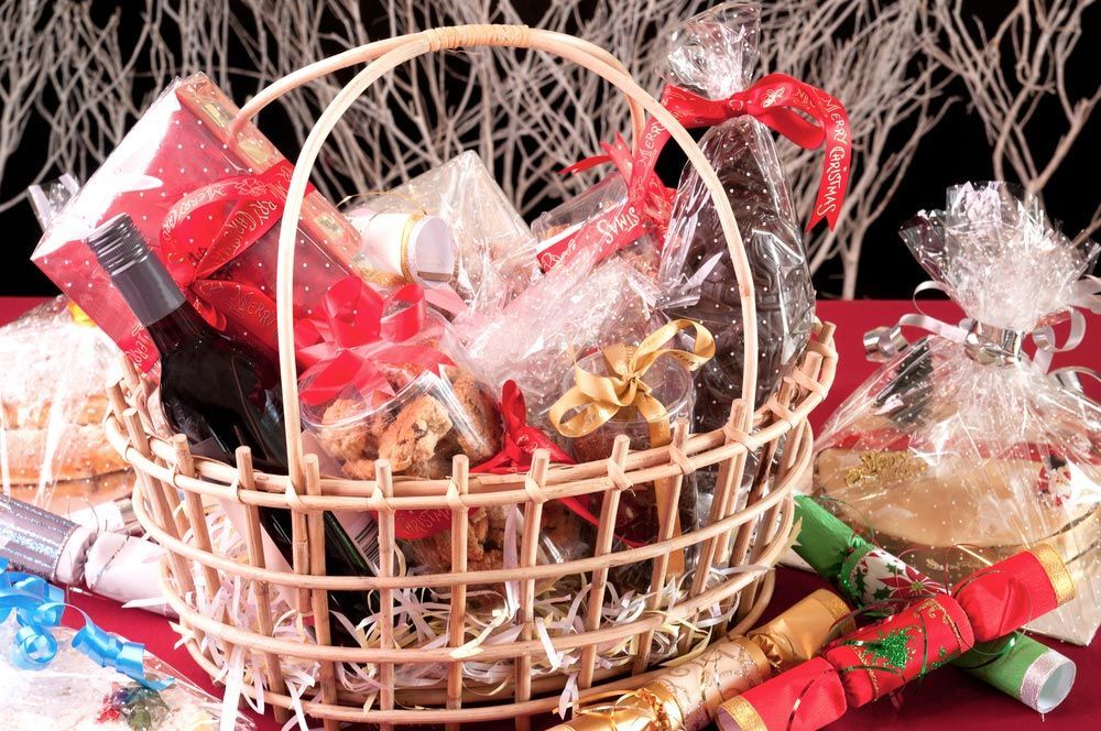 A Wicker Basket Filled with Gifts and Crackers on A Table — Pick-A-Bunch Florists & Gifts In Sarina, QLD
