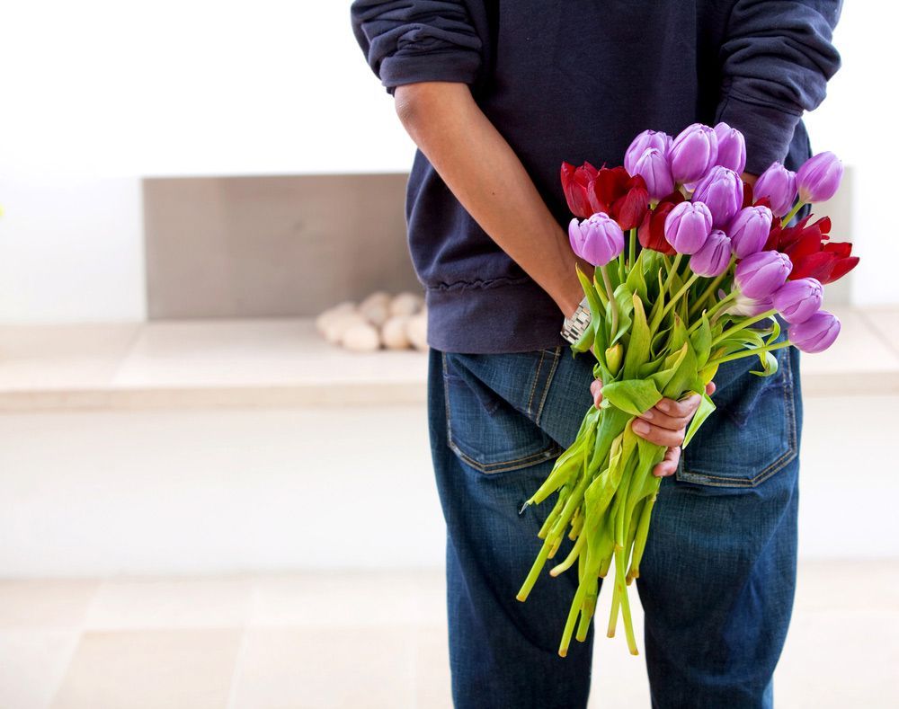 A Person Is Holding a Bouquet of Flowers Behind Their Back — Pick-A-Bunch Florists & Gifts In Koumala, QLD