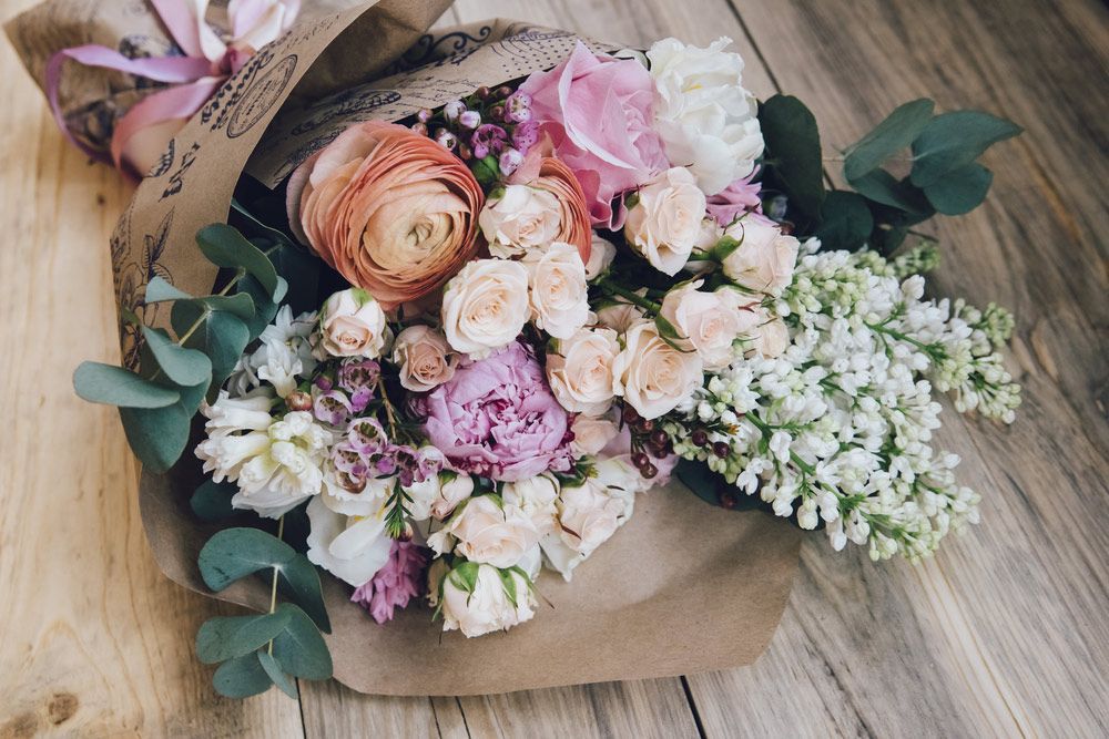 A Bouquet of Flowers Wrapped in Brown Paper — Pick-A-Bunch Florists & Gifts In Alligator Creek, QLD