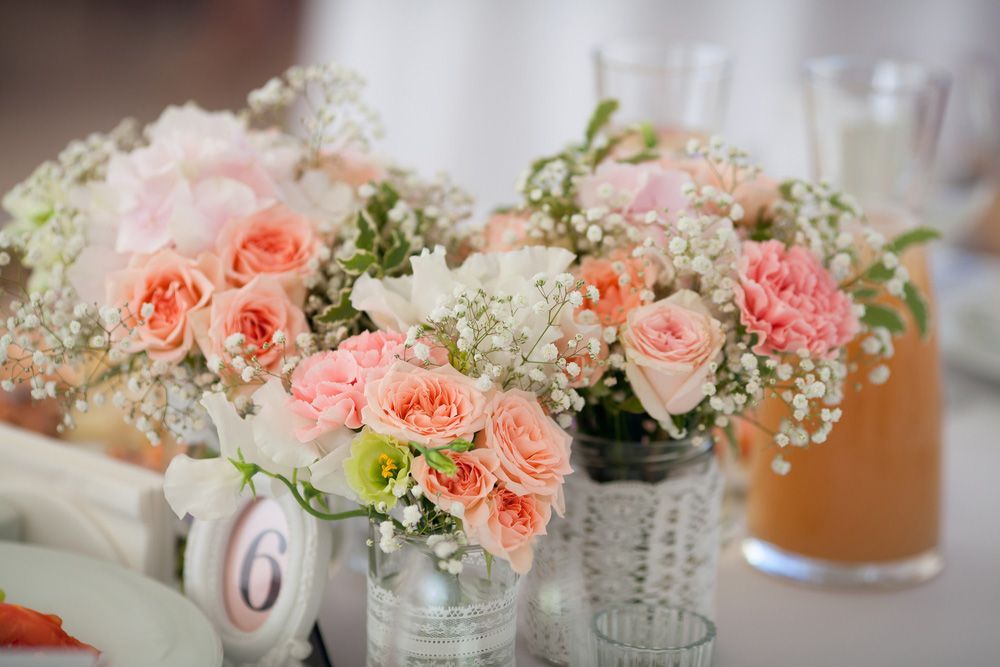Two Vases Filled with Pink and White Flowers Are on A Table — Pick-A-Bunch Florists & Gifts In Armstrong Beach, QLD