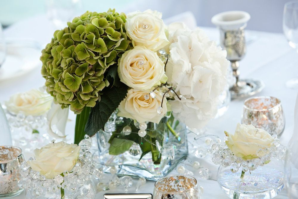 A Vase Filled with White Roses and Green Hydrangea Is on A Table — Pick-A-Bunch Florists & Gifts In Hay Point, QLD