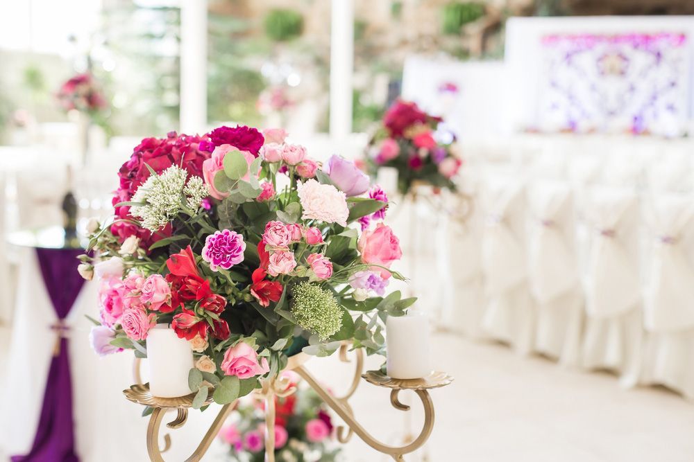A Candle Holder Filled with Flowers and Candles in A Room — Pick-A-Bunch Florists & Gifts In Alligator Creek, QLD
