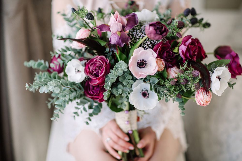 A Woman Is Holding a Bouquet of Flowers in Her Hands — Pick-A-Bunch Florists & Gifts In Koumala, QLD