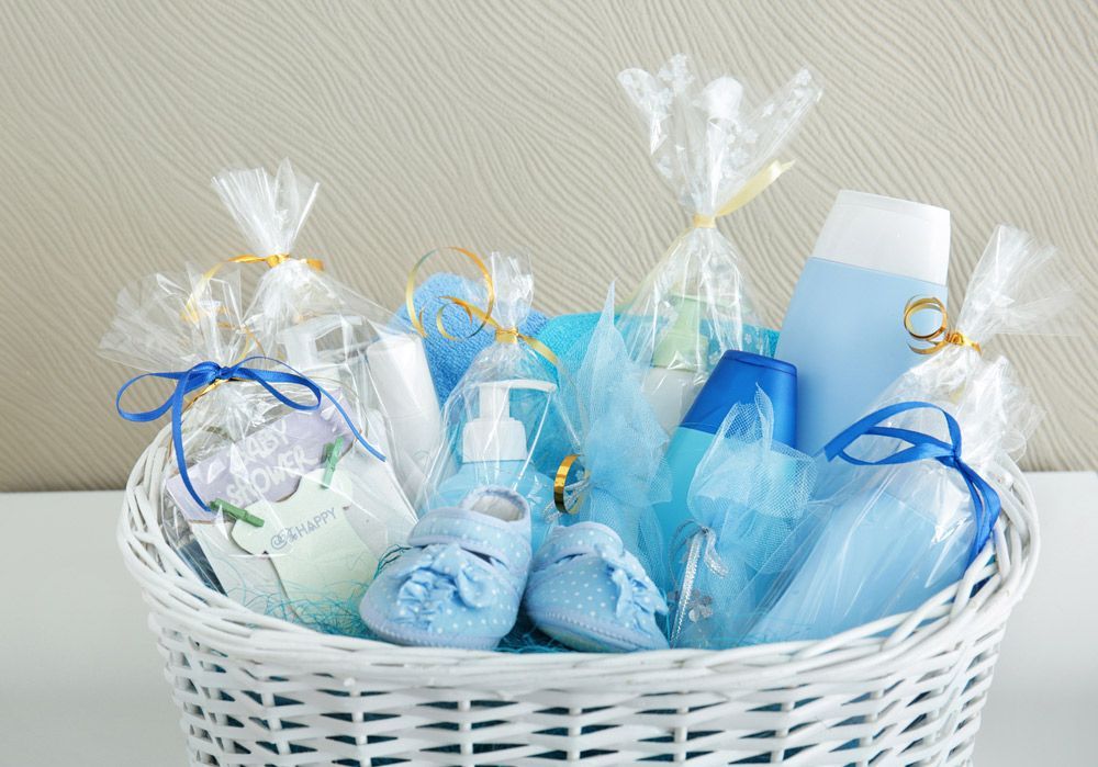 A White Wicker Basket Filled with Baby Supplies for A Baby Boy — Pick-A-Bunch Florists & Gifts In Sarina, QLD
