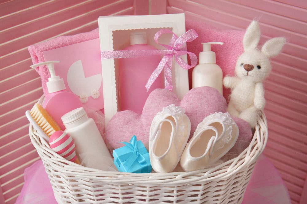 A Wicker Basket Filled with Baby Supplies for A Baby Girl — Pick-A-Bunch Florists & Gifts In Sarina, QLD