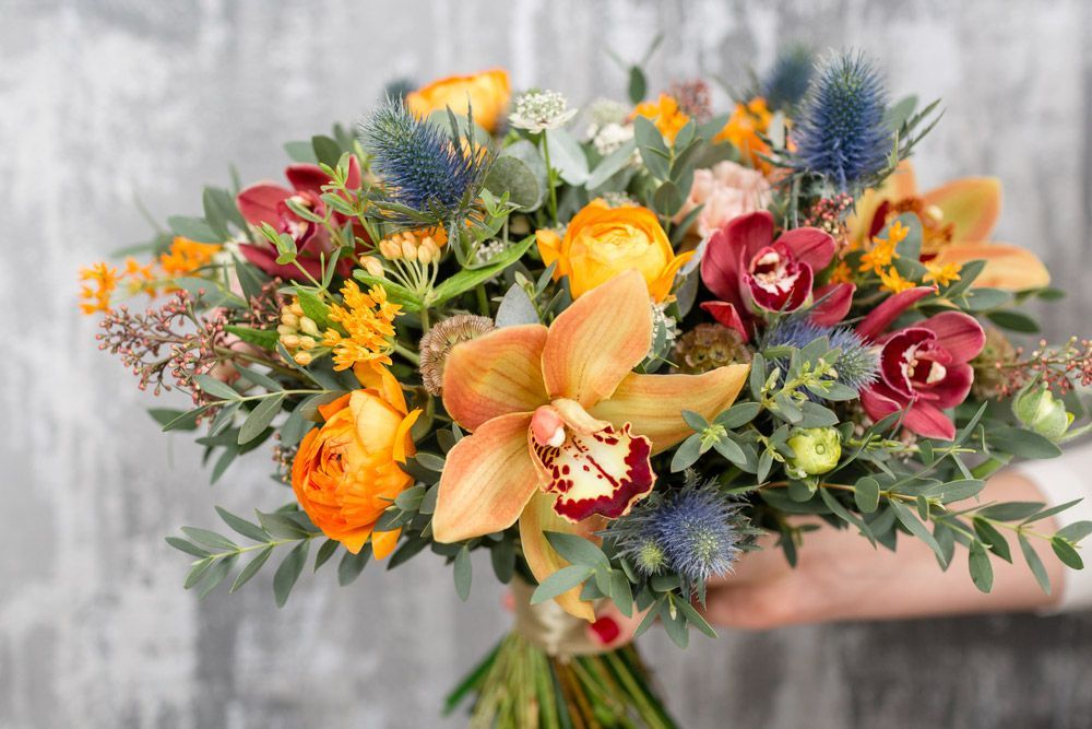 A Person Is Holding a Bouquet of Flowers in Their Hand — Pick-A-Bunch Florists & Gifts In Hay Point, QLD