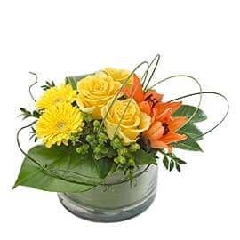 A Vase Filled with Yellow Roses and Orange Lilies on A White Background — Pick-A-Bunch Florists & Gifts In Sarina, QLD