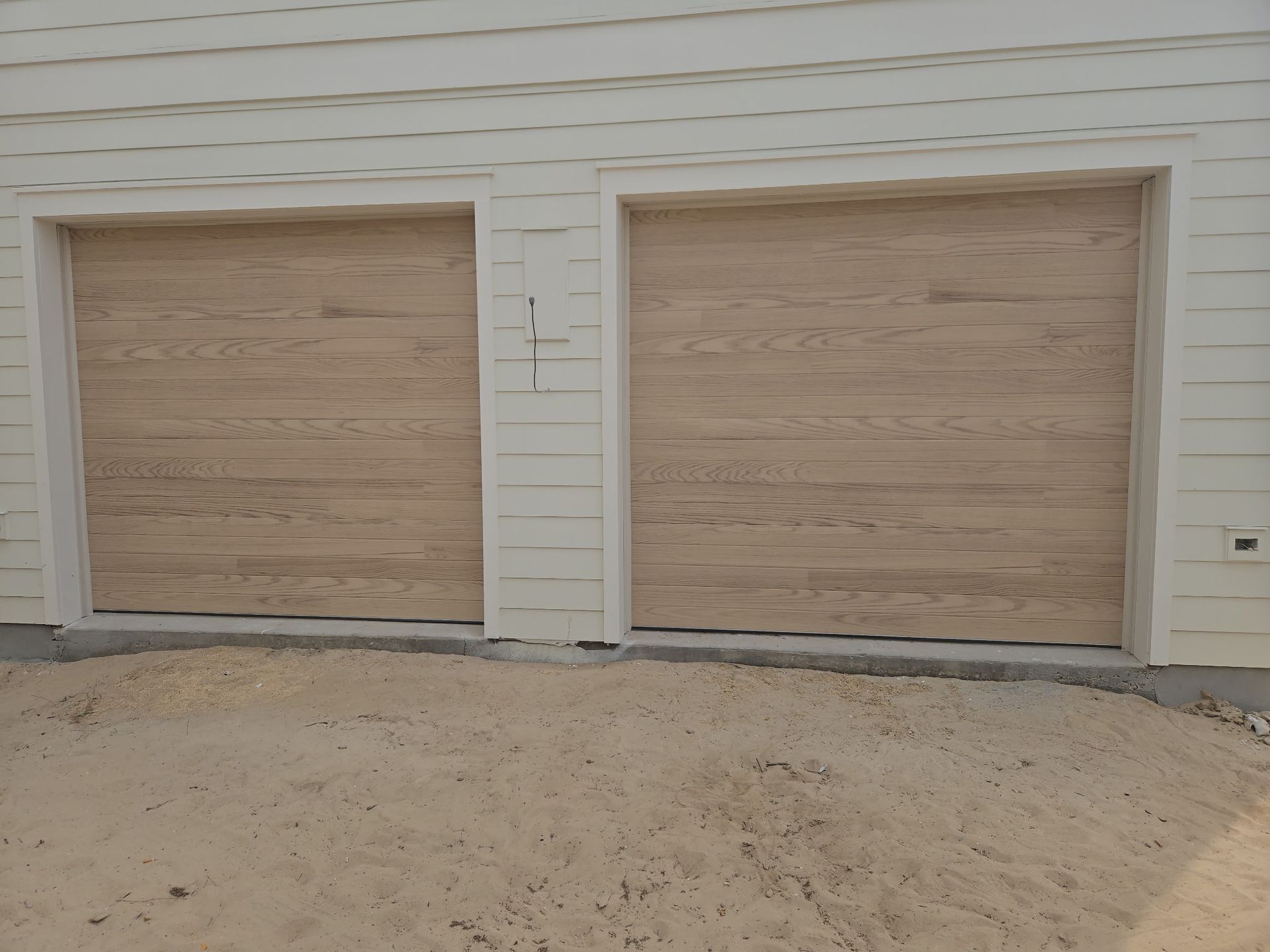 Garage Door Repair Company Using Drill On Door