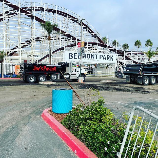 Asphalt paving in San Diego, CA with a Belmont Park rollercoaster in the background.