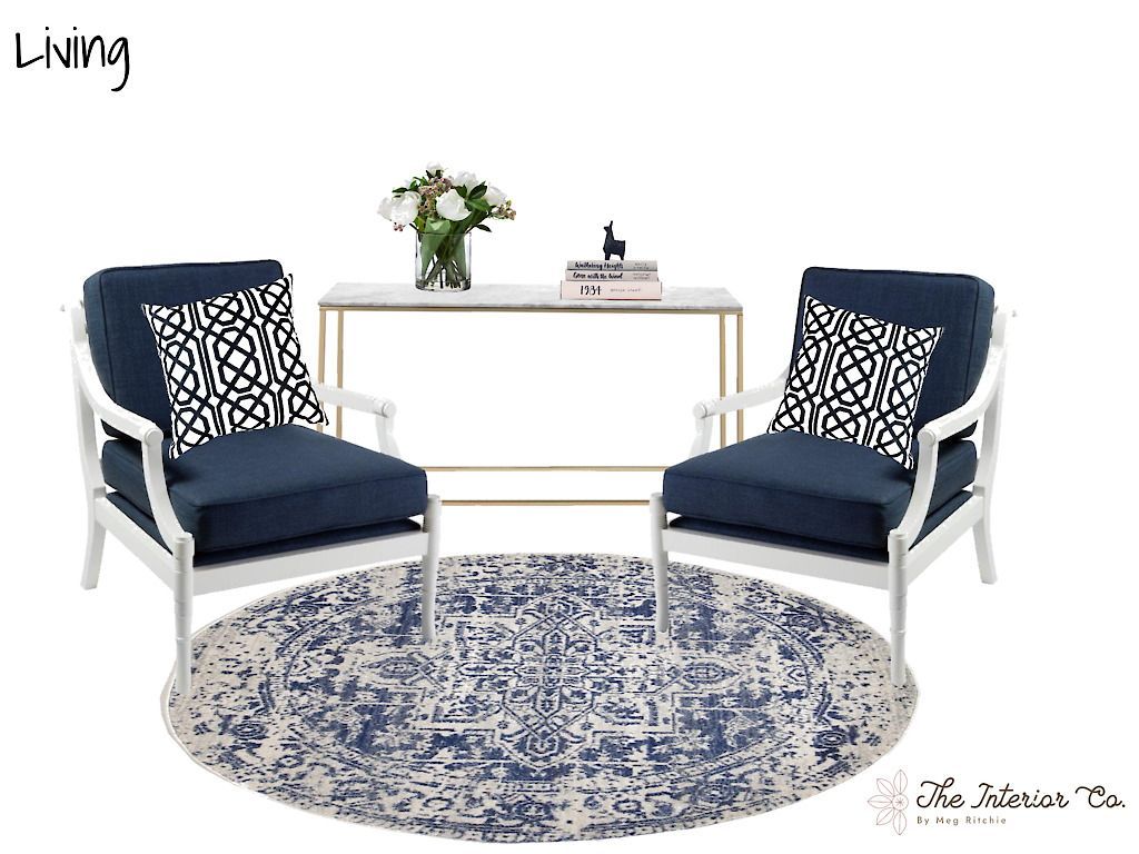 A living room with two chairs , a table , and a rug.