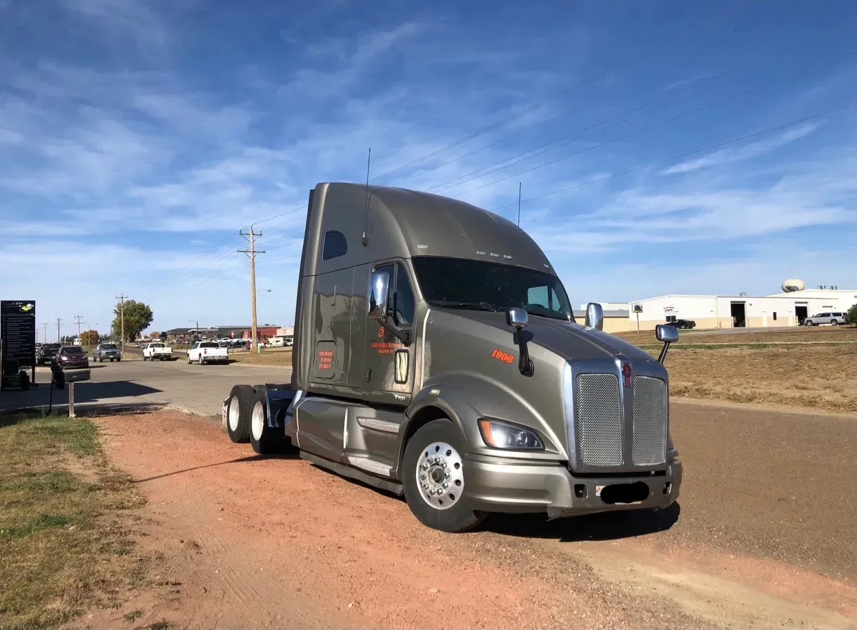 A semi truck is parked on the side of the road.