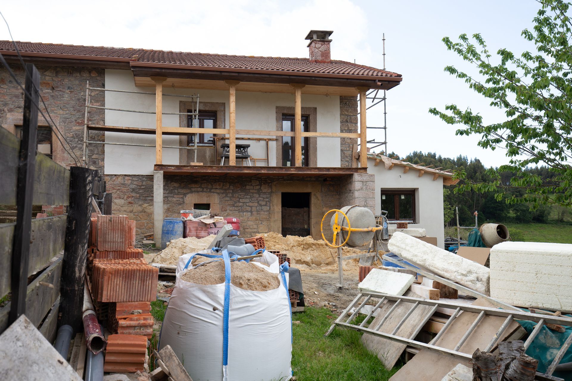 A house that is being built with a lot of bricks in front of it