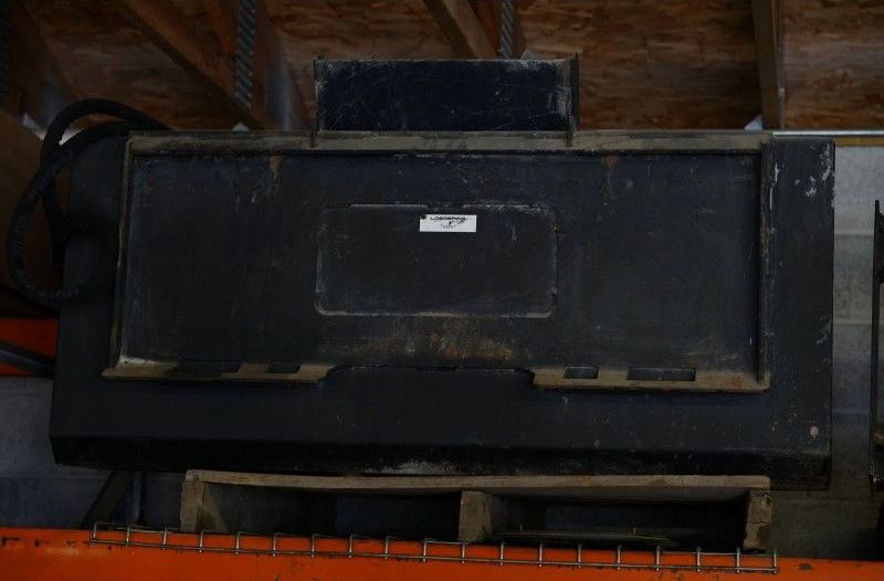 A black box is sitting on top of a wooden pallet.