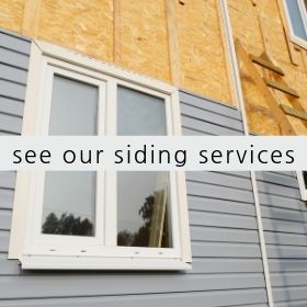 A house exterior showing gray horizontal siding being installed next to an unfinished wooden wall with a window.