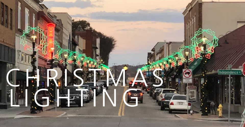 A two-story suburban home with red brick and grey horizontal siding, with the text