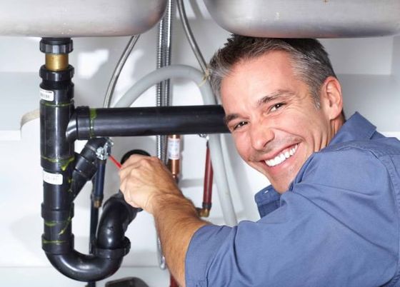 Plumber for AA Plumbing Company works on sink repairs