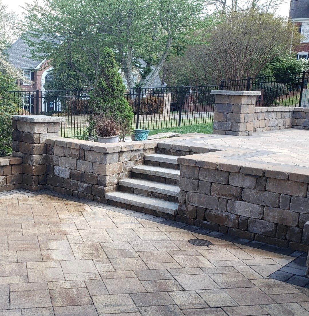 A brick patio with stairs leading up to it