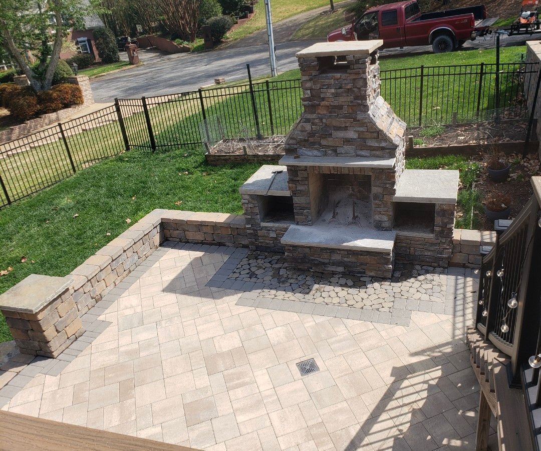 There is a fireplace in the middle of the patio.