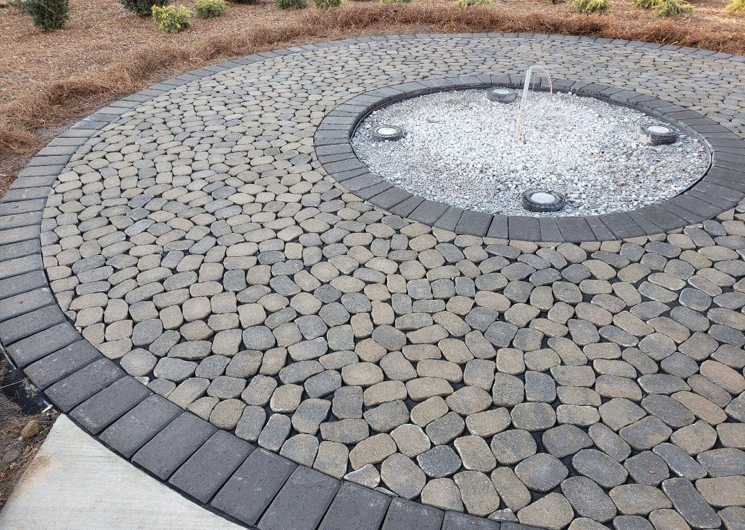 There is a fountain in the middle of the patio.