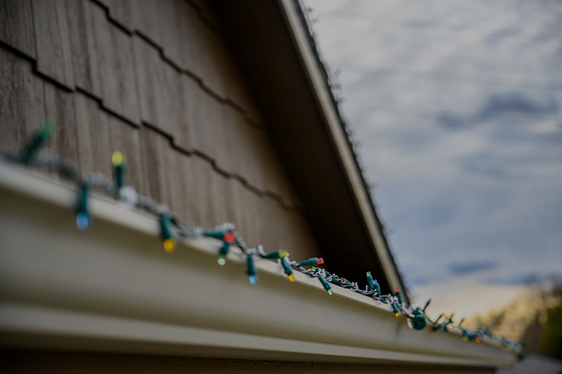 A bunch of christmas lights are hanging from the side of a house.