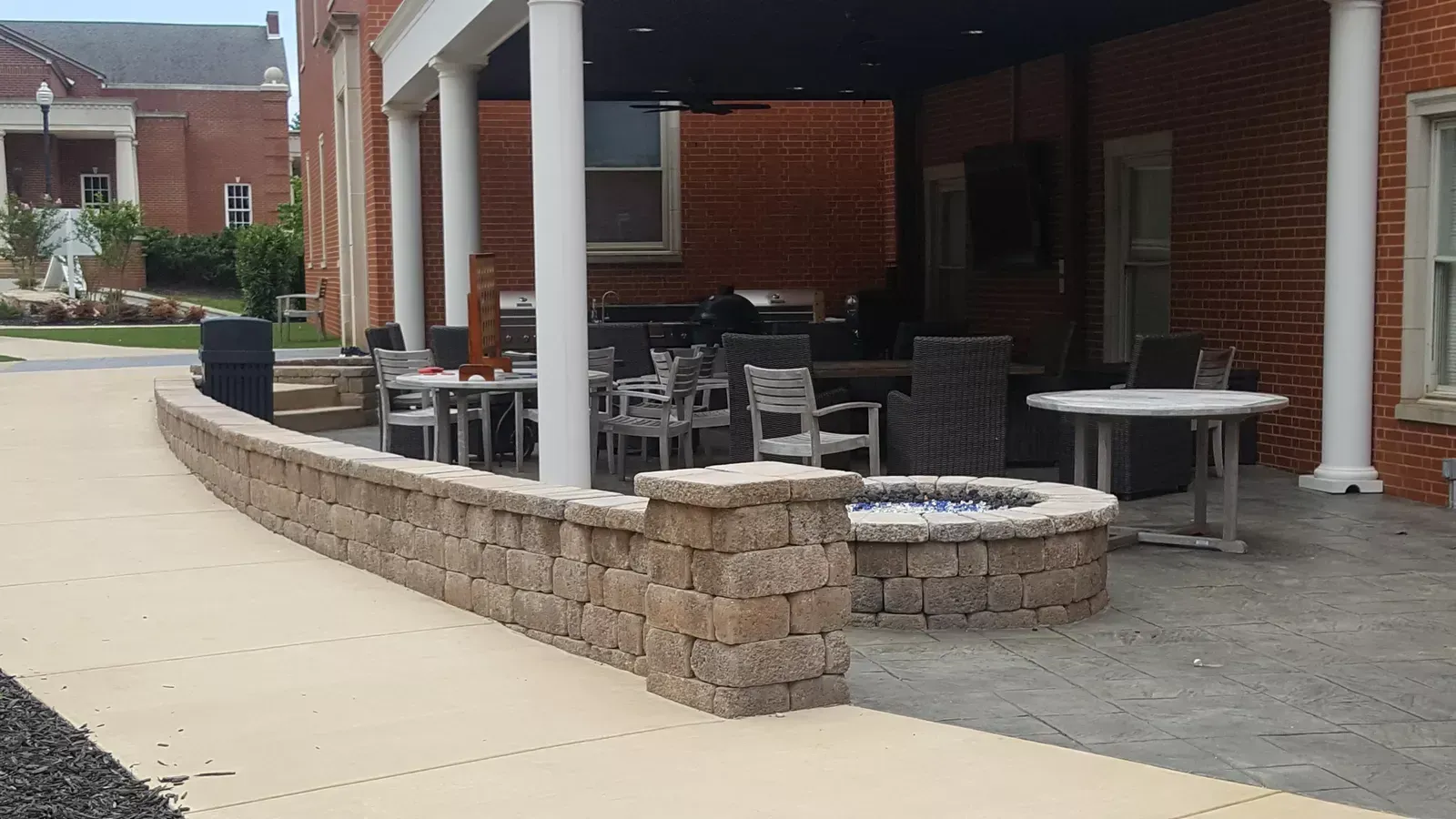 A brick building with a fire pit in front of it