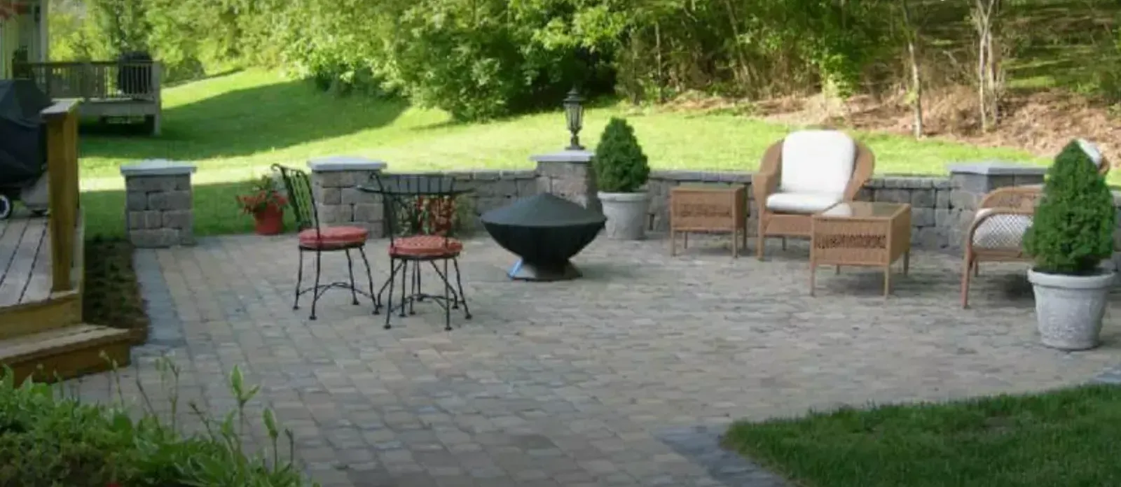 There is a fire pit in the middle of the patio.