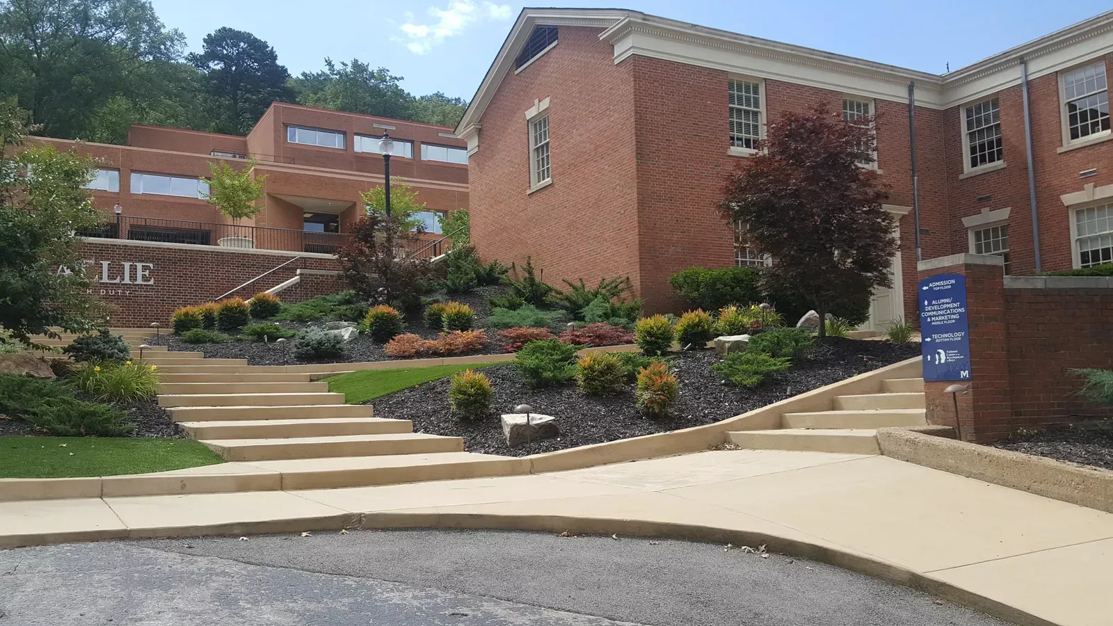 A large brick building with stairs leading up to it