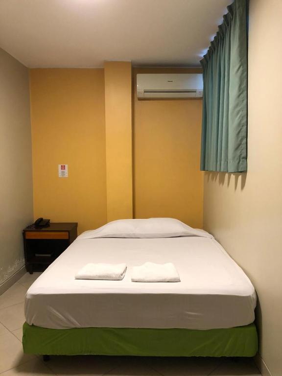 Una habitación de hotel con una cama y una ventana