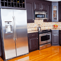 Thousand Palms Appliances — Man Repairing a Washing Machine in Thousand Palms, CA