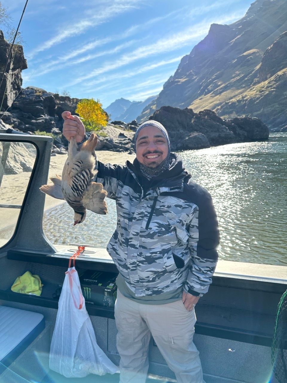 Chris holding duck he shot during hunt trip