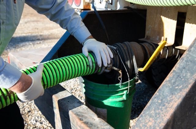 Septic pumping line being connected to valve on truck