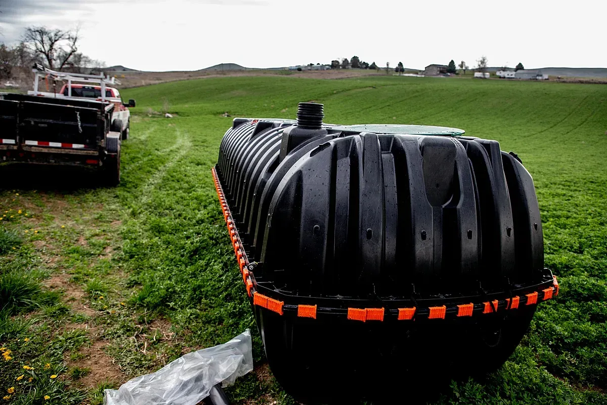 Plastic septic tank by American Rooter & Drain work truck