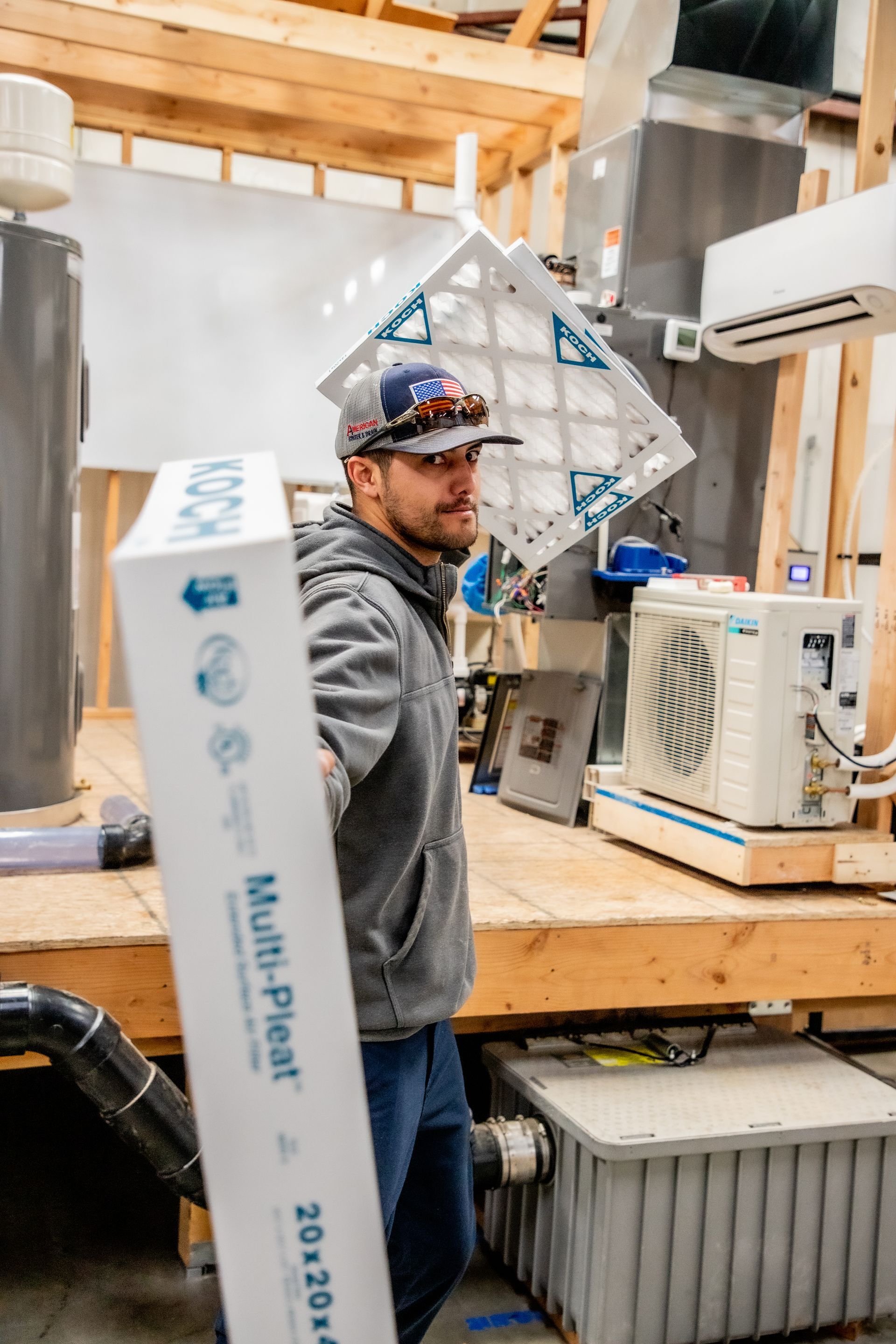 HVAC Technician holding air filters out in your direction.