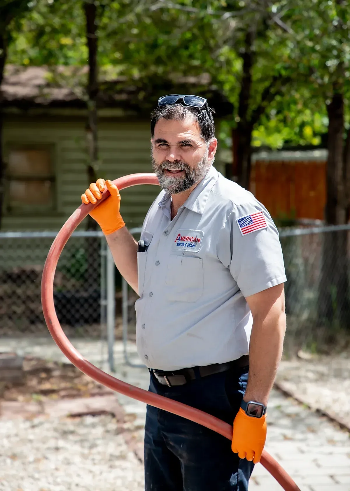 Plumber carrying hose on job-site