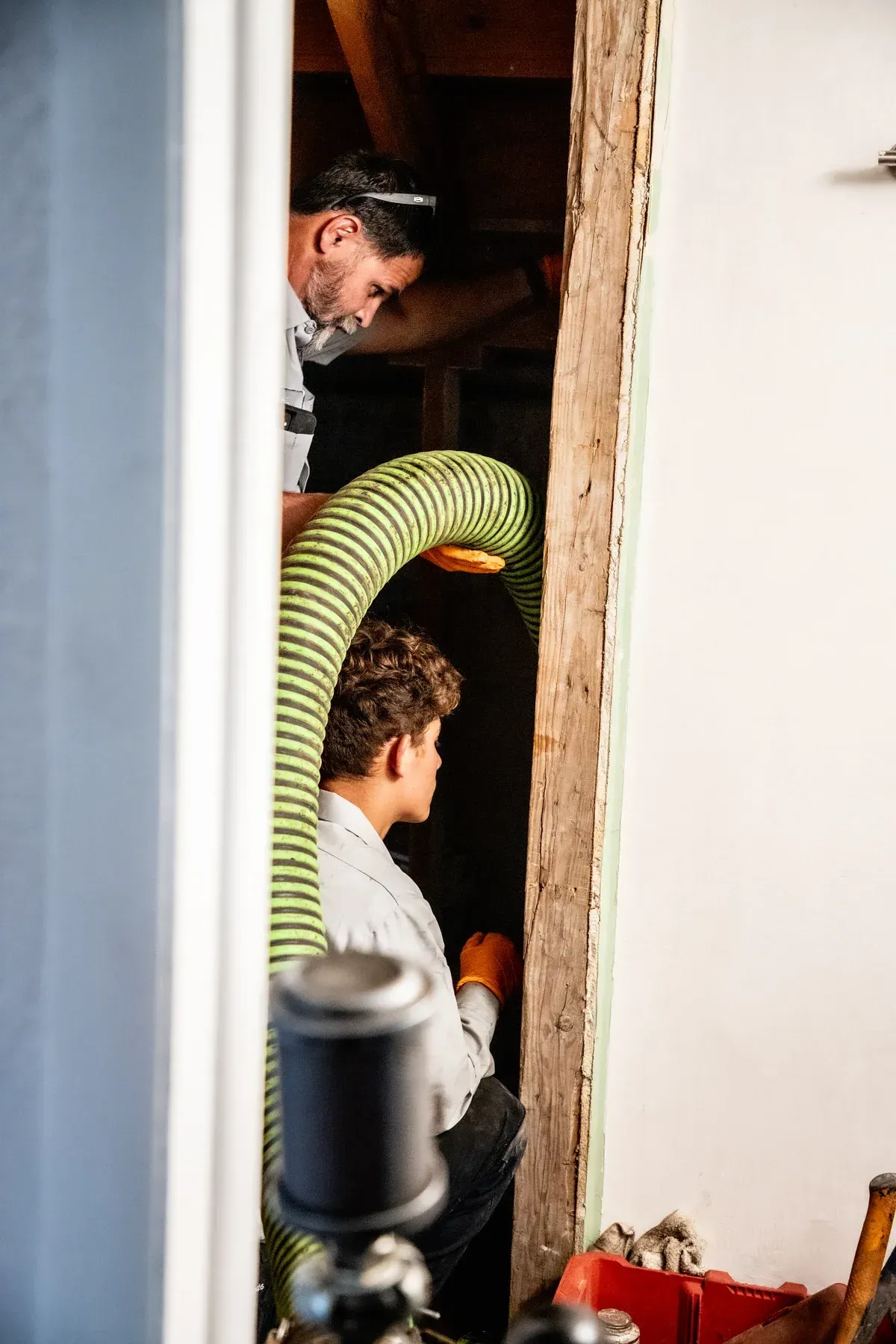 Plumbers working to pump out pipes